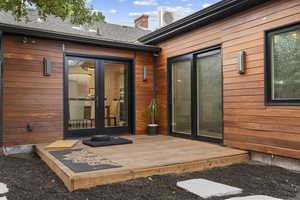 Doorway to property with french doors and a deck