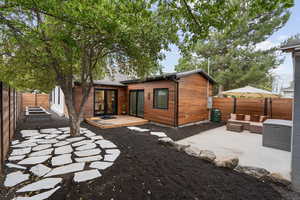 Rear view of property with french doors, a patio, and an outdoor living space