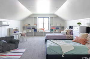 Bedroom featuring lofted ceiling and carpet flooring