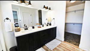 Bathroom with double sink vanity and hardwood / wood-style floors