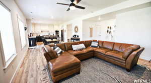 Living room featuring light hardwood / wood-style flooring and ceiling fan