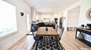 Dining space with light wood-type flooring and sink