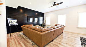 Living room featuring ceiling fan and light hardwood / wood-style floors