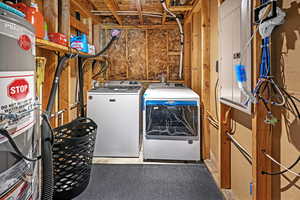 Interior space featuring water heater and washing machine and dryer