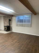 Basement family room with wood look tile and wood stove