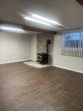 Family room with hardwood look tile and wood stove