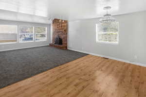 Main floor living room with fireplace.  Same carpet as last picture, just different lighting.