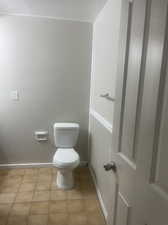 Bathroom with toilet and tile patterned flooring