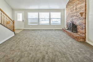 Main floor living room with fireplace.  Same carpet as next picture, just different lighting.