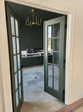 Entryway with french doors and a chandelier