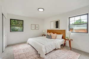 Carpeted bedroom featuring a closet