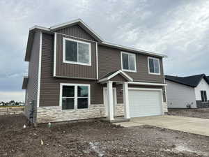 View of front facade featuring a garage