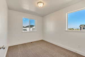 Unfurnished room with carpet flooring