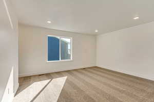 Spare room with light colored carpet