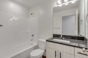 Full bathroom with vanity, toilet, and shower / bath combination