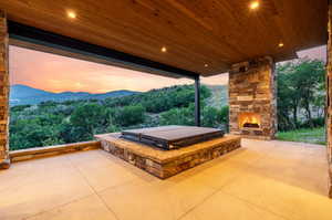 Heated patio with hot tub and fireplace lower level