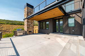 Heated patio main level with grill and fireplace