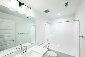 Full bathroom featuring vanity, toilet, and shower / bathing tub combination