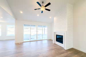 Unfurnished living room with ceiling fan, a healthy amount of sunlight, and light wood-type flooring