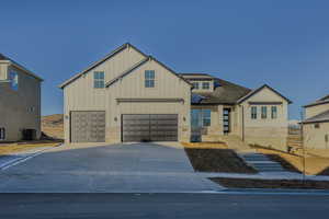 View of front of home featuring cooling unit and a garage