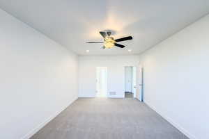 Unfurnished room featuring light carpet and ceiling fan