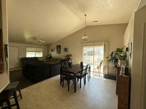 Dining area featuring high vaulted ceiling, ceiling fan