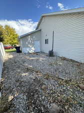 View of side of home with central AC unit