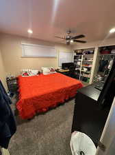 Primary bedroom featuring brand new carpet, ceiling fan, can lighting, bulit-in shelving