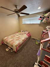 3rd bedroom with can lighting, ceiling fan and brand new carpet