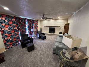 Living room with original wood-burning brick fireplace, ceiling fan and brand new carpet