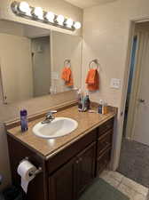 Main full bathroom featuring tile floors and vanity