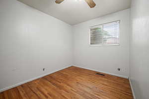 Spare room featuring ceiling fan and wood-type flooring