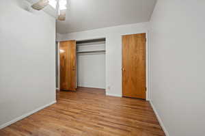 Unfurnished bedroom with ceiling fan, light hardwood / wood-style floors, and a closet