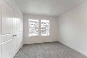 Empty room featuring light carpet