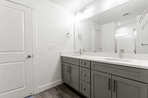 Bathroom featuring a textured ceiling, vanity, and hardwood / wood-style flooring