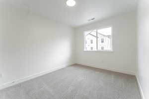 Unfurnished room with light colored carpet, visible vents, and baseboards