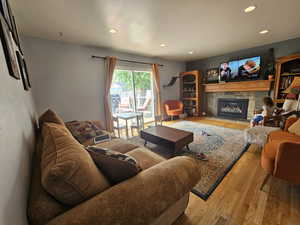 Living room with light hardwood / wood-style flooring and a fireplace