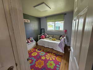 Bedroom with hardwood / wood-style floors