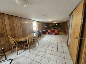 Tiled dining area with wood walls