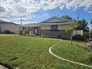 Ranch-style house featuring a front lawn