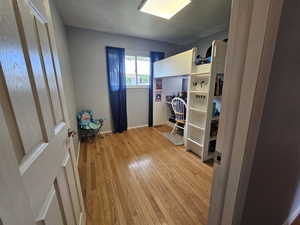 Bedroom with light hardwood / wood-style flooring