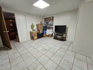 Interior space featuring light tile patterned flooring and wooden walls