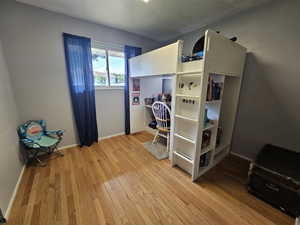 Bedroom with light hardwood / wood-style flooring