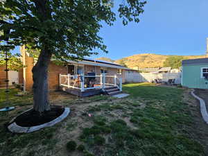 View of yard with a deck with mountain view