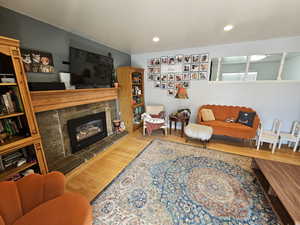 Living room with wood-type flooring and a fireplace