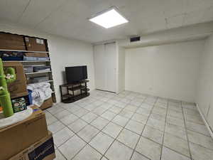 Basement with light tile patterned flooring