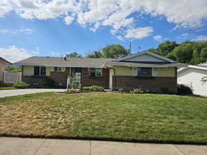 Ranch-style home with a front yard