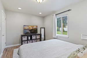 Bedroom with wood-type flooring