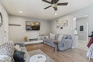 Living room featuring light hardwood / wood-style flooring and ceiling fan