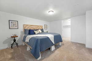 Bedroom featuring a walk in closet, carpet flooring, and a closet